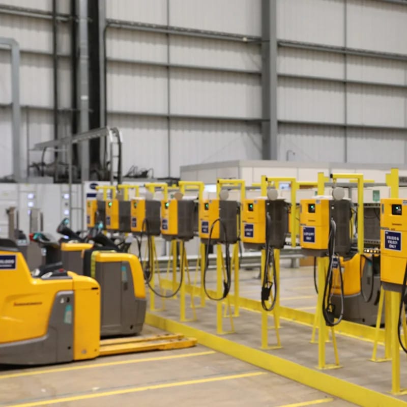 Charging stations inside a large industrial warehouse.
